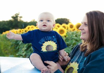 Baby and mom wearing Double G Sunflower shirts